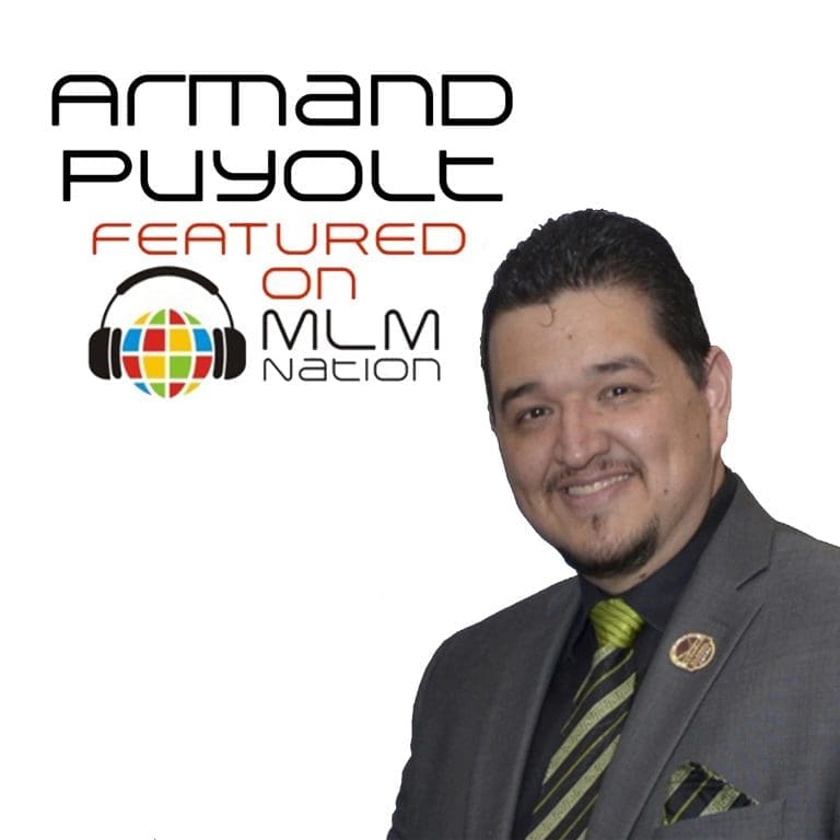 Armand Puyolt smiling confidently in a professional setting, representing his incredible MLM success story before the age of 20.