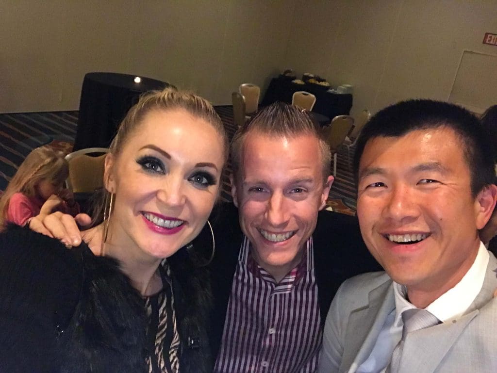 Nadya Melton and John Melton with Simon Chan at a MLM event